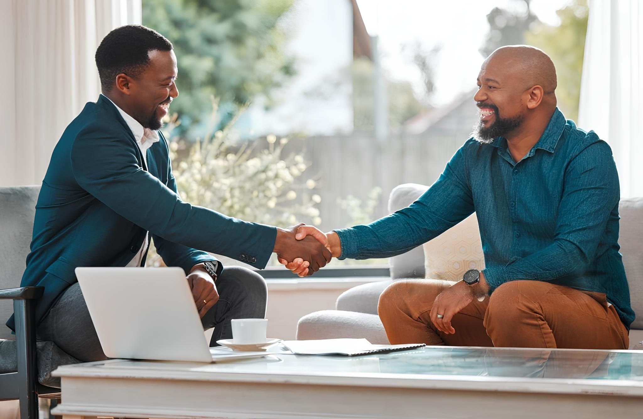 Two professionals shaking hands after a meeting